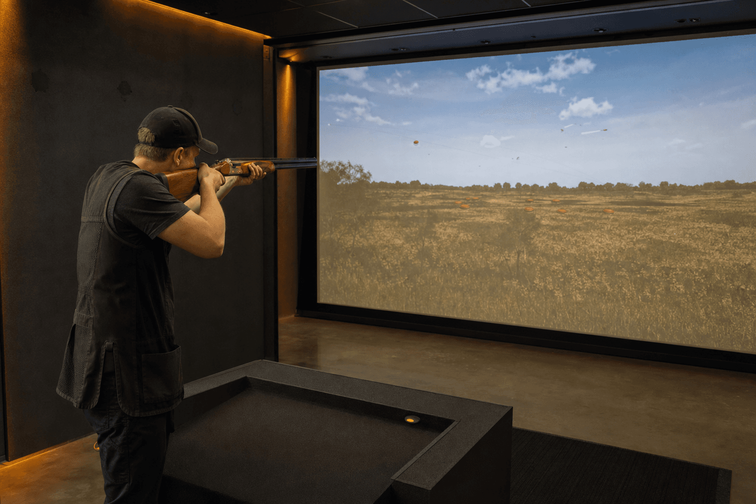 Shooter training with a real shotgun in a Marksman indoor simulator