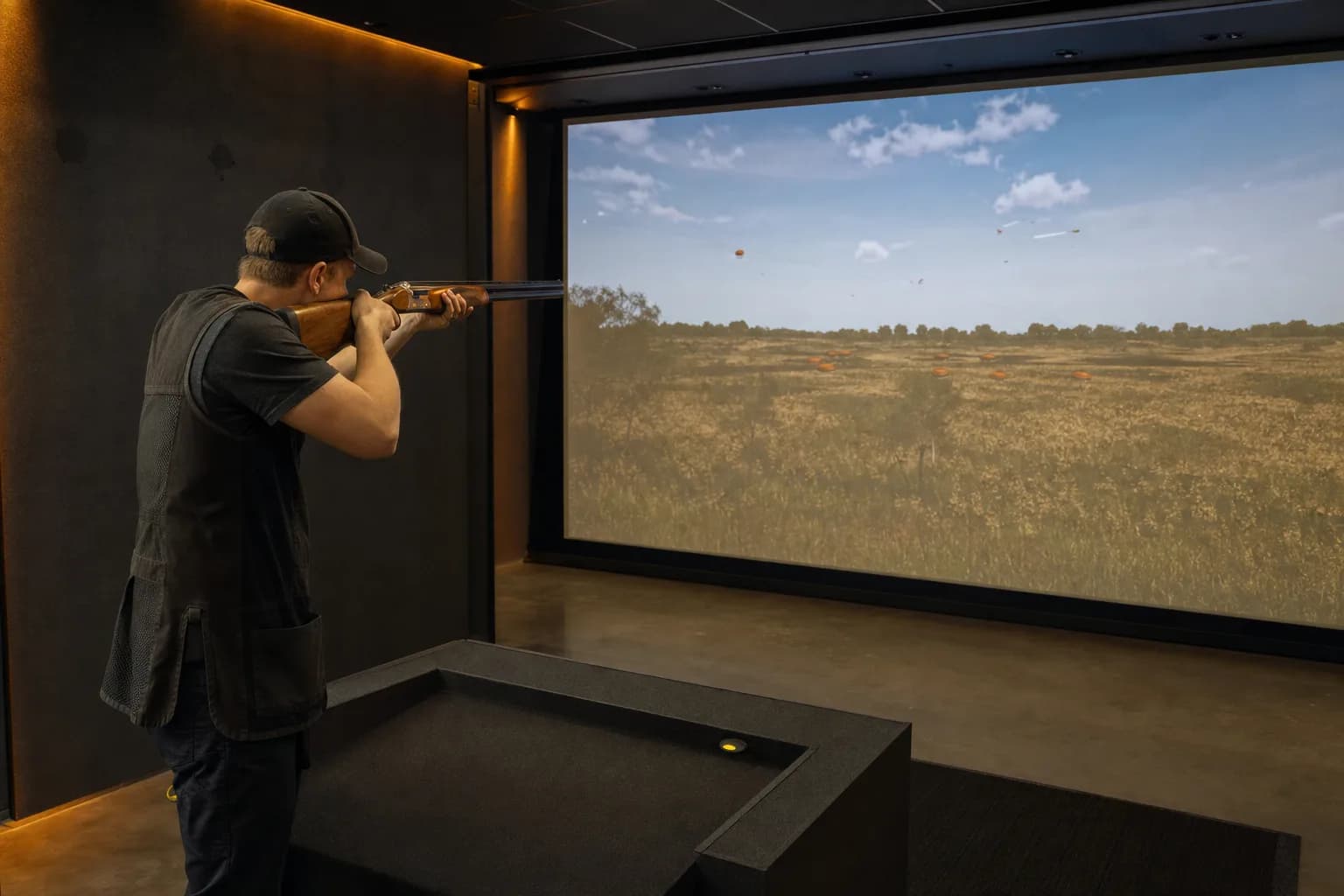 Shooter training with a real shotgun in a Marksman indoor simulator
